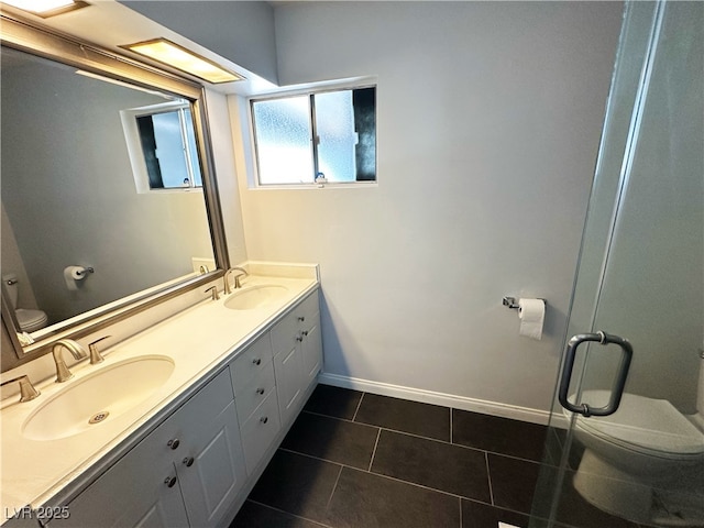 1304 Bonita Ave, Las Vegas, NV 89104 - full bath featuring toilet, double vanity, baseboards, and tile patterned floors