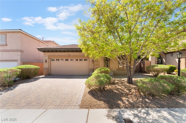 9025 Loggers Mill Ave, Las Vegas, NV 89143 - view of front facade featuring stucco siding, a garage, and decorative driveway