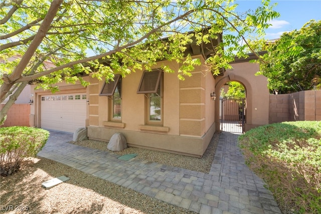 9025 Loggers Mill Ave, Las Vegas, NV 89143 - view of front facade featuring a gate, stucco siding, and an attached garage