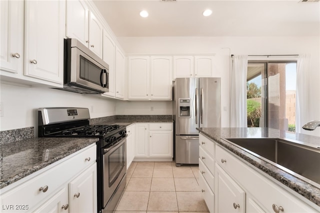 9025 Loggers Mill Ave, Las Vegas, NV 89143 - kitchen featuring stainless steel appliances, a sink, white cabinets, recessed lighting, and light tile patterned flooring