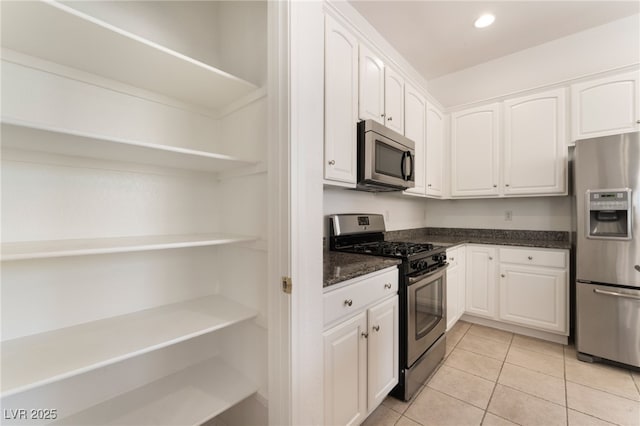9025 Loggers Mill Ave, Las Vegas, NV 89143 - kitchen with appliances with stainless steel finishes, open shelves, white cabinets, light tile patterned floors, and recessed lighting