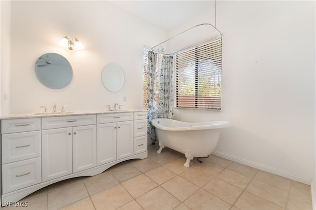 9025 Loggers Mill Ave, Las Vegas, NV 89143 - bathroom with a freestanding bath, tile patterned flooring, double vanity, a shower with curtain, and baseboards