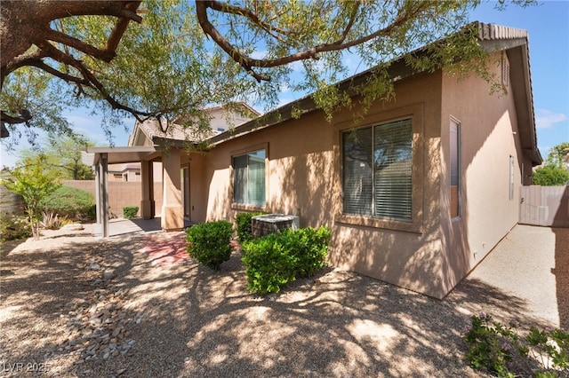 9025 Loggers Mill Ave, Las Vegas, NV 89143 - view of property exterior featuring stucco siding, a patio, and central AC