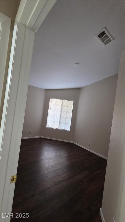 6113 Desert Haven Rd, Las Vegas, NV 89130 - spare room featuring dark wood-type flooring and baseboards