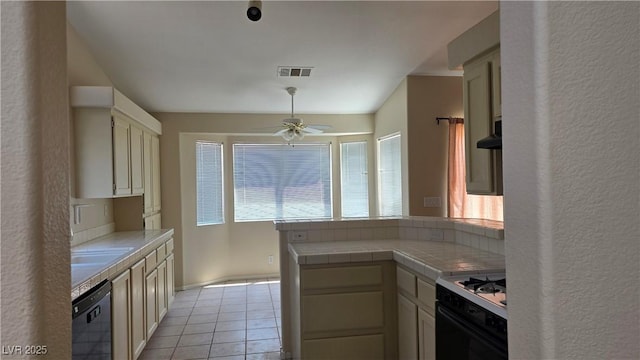6113 Desert Haven Rd, Las Vegas, NV 89130 - kitchen with gas stove, dishwasher, tile countertops, ceiling fan, and light tile patterned floors