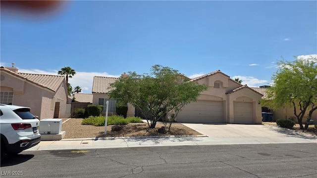 6113 Desert Haven Rd, Las Vegas, NV 89130 - mediterranean / spanish house with an attached garage, stucco siding, concrete driveway, and a tile roof