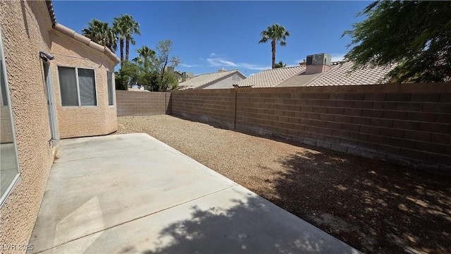 6113 Desert Haven Rd, Las Vegas, NV 89130 - fenced backyard with a patio and cooling unit