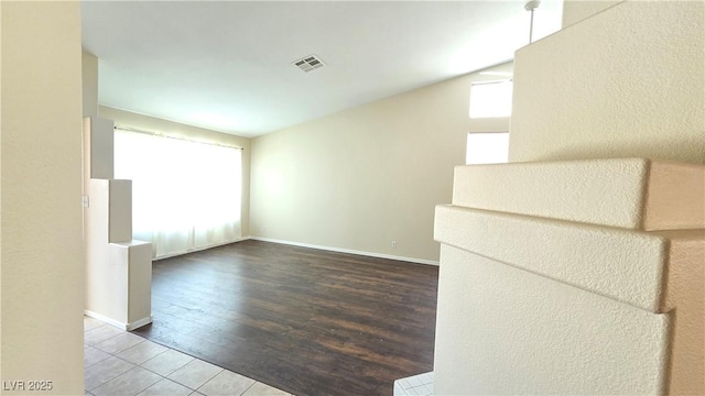 6113 Desert Haven Rd, Las Vegas, NV 89130 - tiled empty room with vaulted ceiling and baseboards