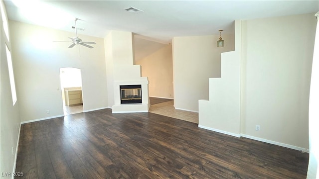 6113 Desert Haven Rd, Las Vegas, NV 89130 - unfurnished living room featuring a ceiling fan, wood-type flooring, vaulted ceiling, a multi sided fireplace, and baseboards