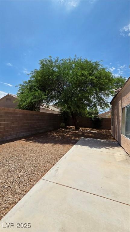 6113 Desert Haven Rd, Las Vegas, NV 89130 - fenced backyard with a patio area