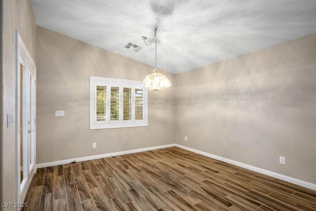 8340 Jeremiahs Lodge Ave, Las Vegas, NV 89131 - empty room with a chandelier, dark wood-type flooring, baseboards, and lofted ceiling