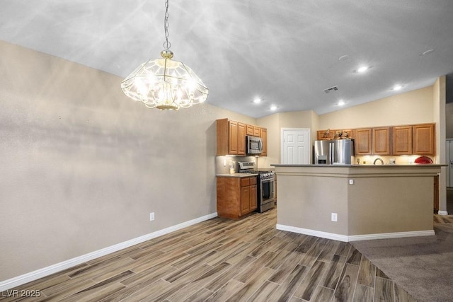 8340 Jeremiahs Lodge Ave, Las Vegas, NV 89131 - kitchen featuring appliances with stainless steel finishes, a chandelier, baseboards, wood finish floors, and brown cabinetry