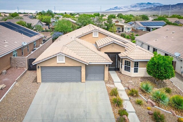 8340 Jeremiahs Lodge Ave, Las Vegas, NV 89131 - single story home with driveway, a tile roof, stucco siding, and a mountain view