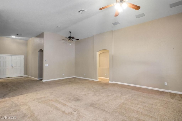8340 Jeremiahs Lodge Ave, Las Vegas, NV 89131 - carpeted empty room featuring arched walkways, a ceiling fan, high vaulted ceiling, and baseboards