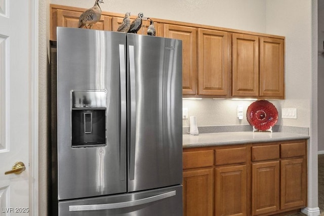 8340 Jeremiahs Lodge Ave, Las Vegas, NV 89131 - kitchen featuring stainless steel fridge, light countertops, and brown cabinets