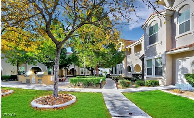 9975 Peace Way Unit 1069, Las Vegas, NV 89147 - view of community featuring an outdoor kitchen, a yard, and a residential view