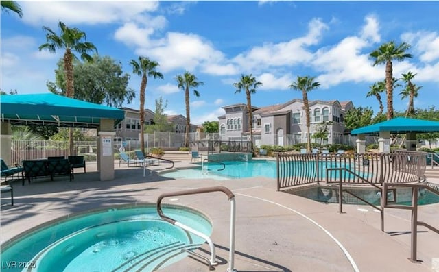 9975 Peace Way Unit 1069, Las Vegas, NV 89147 - community pool with a hot tub, a residential view, and a patio