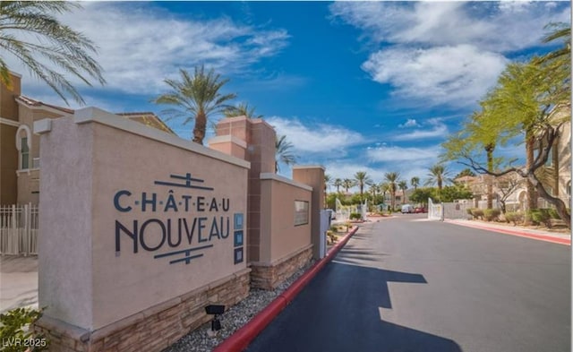 9975 Peace Way Unit 1069, Las Vegas, NV 89147 - view of asphalt road with a gated entry, curbs, and a residential view