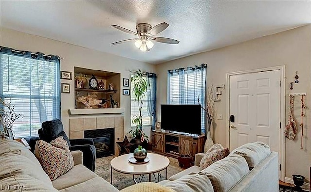 9975 Peace Way Unit 1069, Las Vegas, NV 89147 - living area featuring ceiling fan and a fireplace