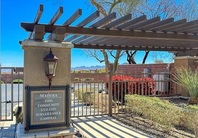 9992 Peak Lookout St, Las Vegas, NV 89178 - view of patio / terrace with a gate, a pergola, and a mountain view