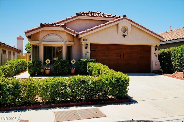 9355 W Viking Rd, Las Vegas, NV 89147 - mediterranean / spanish-style house with a garage, concrete driveway, stucco siding, and a tile roof