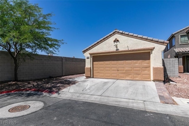 1905 Eskam St, Las Vegas, NV 89156 - view of front facade featuring a garage and stucco siding