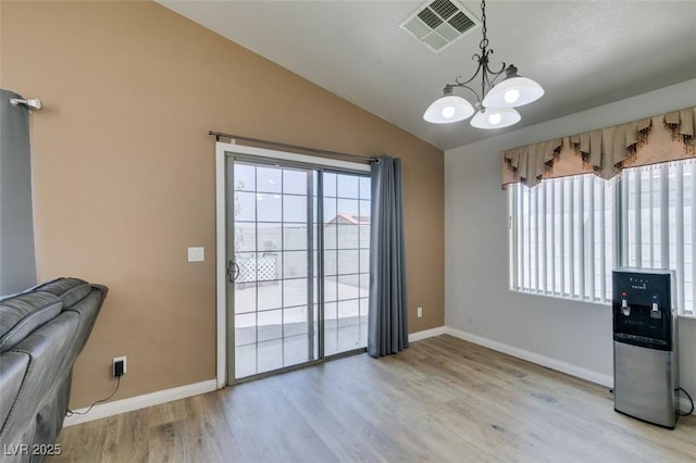 1905 Eskam St, Las Vegas, NV 89156 - unfurnished dining area with a chandelier, healthy amount of natural light, lofted ceiling, and baseboards