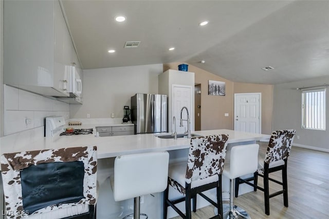 1905 Eskam St, Las Vegas, NV 89156 - kitchen with freestanding refrigerator, a sink, stove, light wood-type flooring, and a peninsula