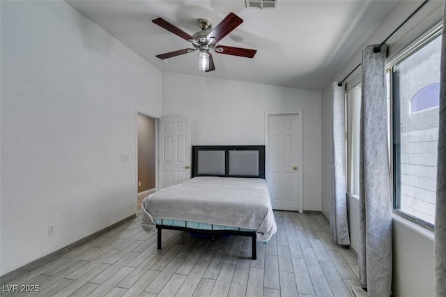 1905 Eskam St, Las Vegas, NV 89156 - bedroom with lofted ceiling, multiple windows, light wood-type flooring, baseboards, and ceiling fan