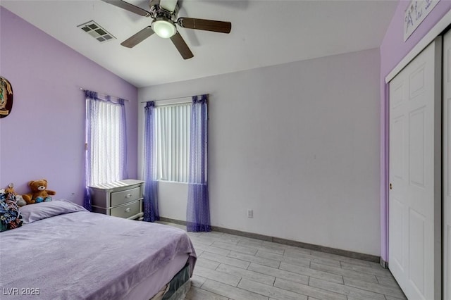 1905 Eskam St, Las Vegas, NV 89156 - bedroom featuring vaulted ceiling, light wood-style floors, a ceiling fan, baseboards, and a closet