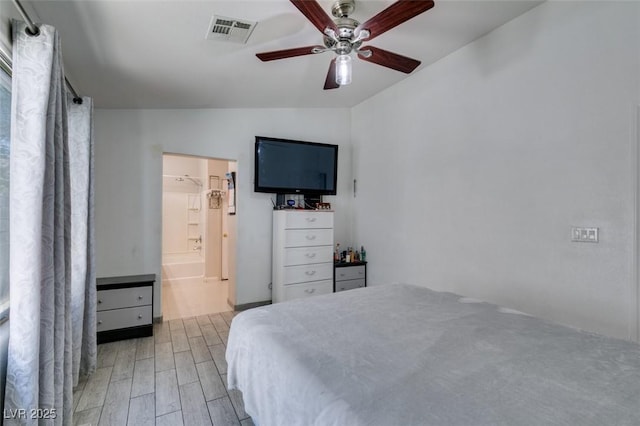 1905 Eskam St, Las Vegas, NV 89156 - bedroom with light wood finished floors, lofted ceiling, a ceiling fan, and ensuite bath