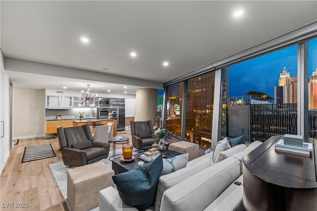 3726 Las Vegas Blvd Unit 606, Las Vegas, NV 89158 - living room with light wood finished floors, a chandelier, recessed lighting, and baseboards