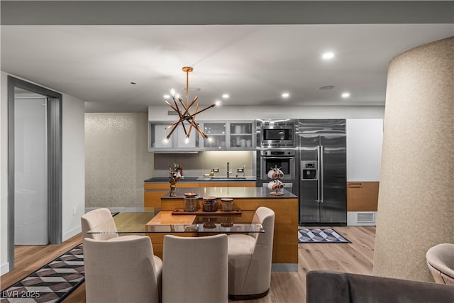 3726 Las Vegas Blvd Unit 606, Las Vegas, NV 89158 - dining area with light wood-style flooring, a chandelier, recessed lighting, and a textured wall