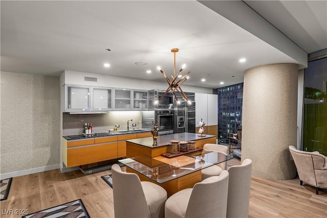 3726 Las Vegas Blvd Unit 606, Las Vegas, NV 89158 - kitchen with stainless steel appliances, light wood-type flooring, dark countertops, a center island, and recessed lighting
