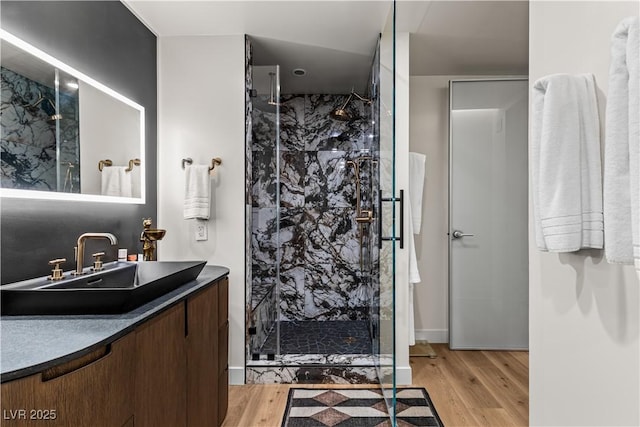 3726 Las Vegas Blvd Unit 606, Las Vegas, NV 89158 - bathroom featuring a marble finish shower, vanity, and wood finished floors