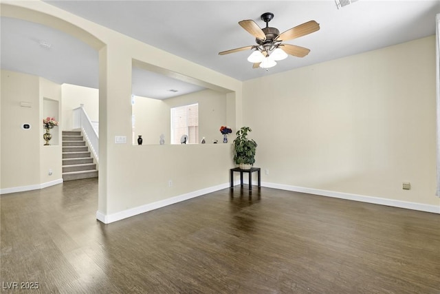 8221 Stoneheather Ct, Las Vegas, NV 89117 - empty room with wood finished floors, stairway, a ceiling fan, and baseboards