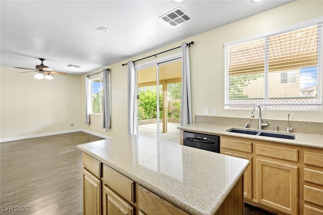 8221 Stoneheather Ct, Las Vegas, NV 89117 - kitchen featuring dishwasher, a sink, ceiling fan, wood finished floors, and a center island