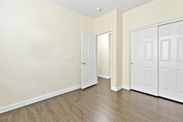8221 Stoneheather Ct, Las Vegas, NV 89117 - unfurnished bedroom with dark wood-type flooring, baseboards, and a closet