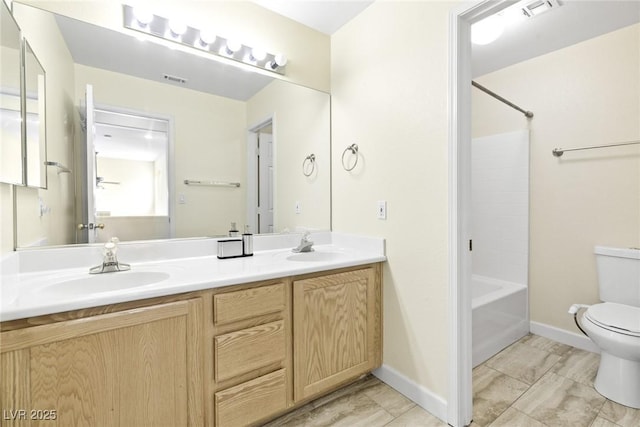 8221 Stoneheather Ct, Las Vegas, NV 89117 - bathroom featuring toilet, double vanity, bathing tub / shower combination, and baseboards