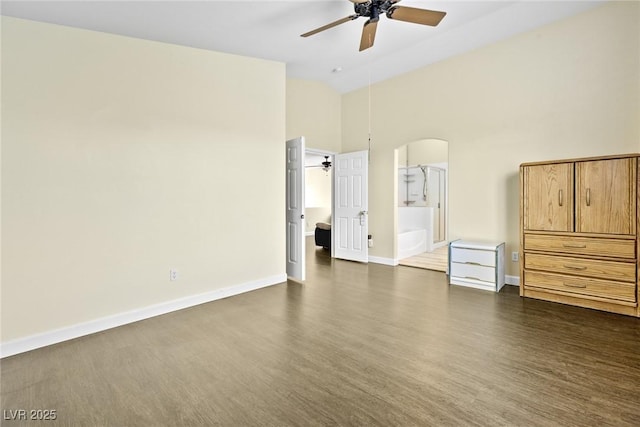 8221 Stoneheather Ct, Las Vegas, NV 89117 - unfurnished bedroom featuring dark wood-style flooring, arched walkways, high vaulted ceiling, baseboards, and a ceiling fan