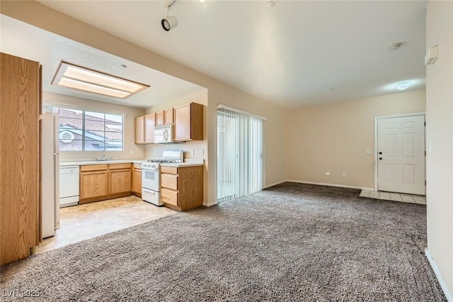 830 Carnegie St Unit 824, Henderson, NV 89052 - kitchen with white appliances, light colored carpet, light countertops, open floor plan, and a sink