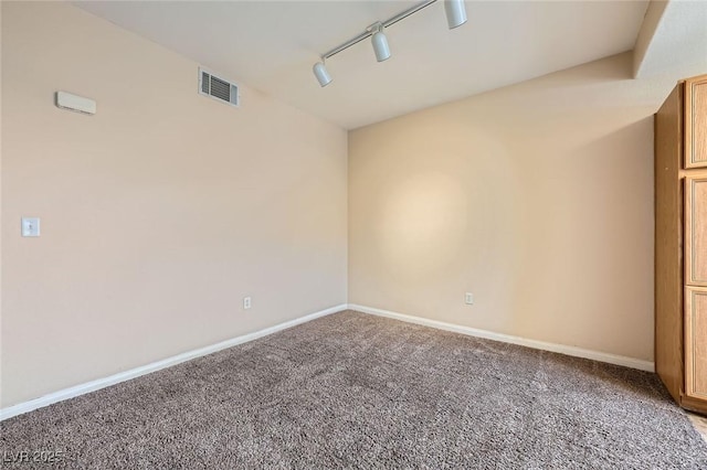 830 Carnegie St Unit 824, Henderson, NV 89052 - empty room with rail lighting, carpet flooring, and baseboards