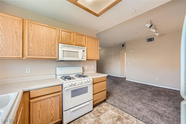 830 Carnegie St Unit 824, Henderson, NV 89052 - kitchen featuring white appliances, light carpet, light brown cabinetry, and light countertops