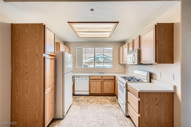 830 Carnegie St Unit 824, Henderson, NV 89052 - kitchen featuring white appliances, a sink, and light countertops