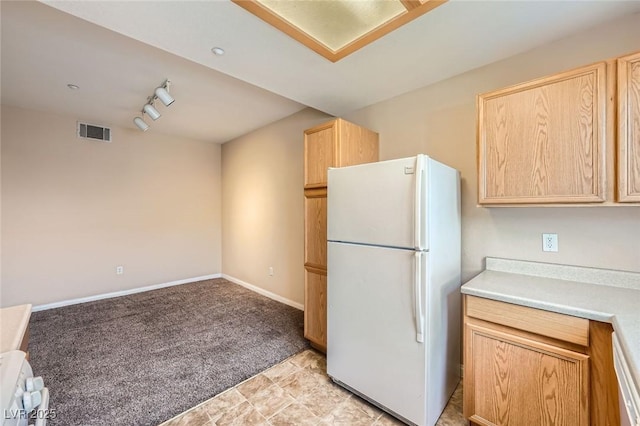 830 Carnegie St Unit 824, Henderson, NV 89052 - kitchen with freestanding refrigerator, light brown cabinets, light carpet, light countertops, and baseboards