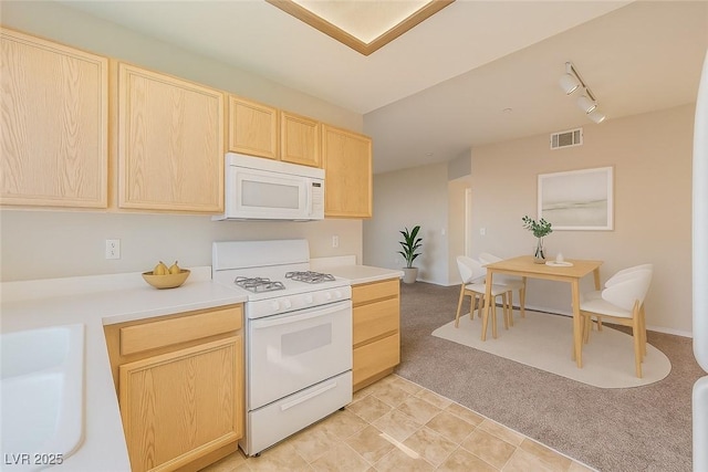 830 Carnegie St Unit 824, Henderson, NV 89052 - kitchen featuring white appliances, light brown cabinetry, rail lighting, light colored carpet, and light countertops