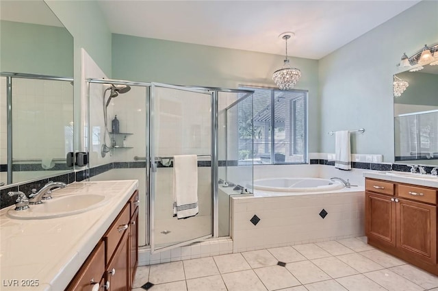 313 Glenridding St, Las Vegas, NV 89183 - bathroom featuring a chandelier, two vanities, tile patterned flooring, and a bath