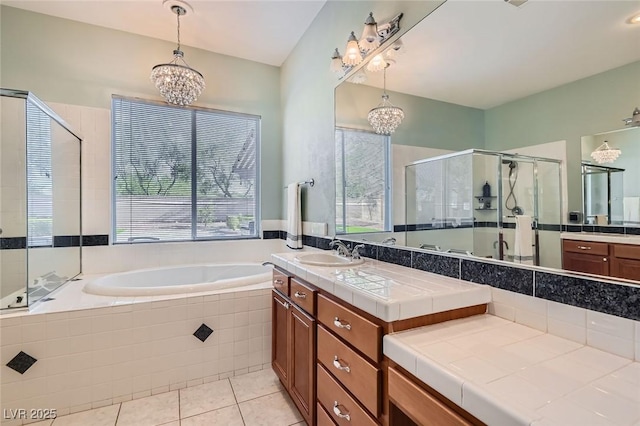 313 Glenridding St, Las Vegas, NV 89183 - bathroom featuring a chandelier, a garden tub, a stall shower, vanity, and tile patterned flooring