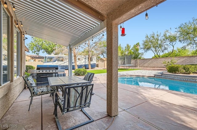 313 Glenridding St, Las Vegas, NV 89183 - fenced backyard featuring a trampoline, a patio, area for grilling, and outdoor dining space