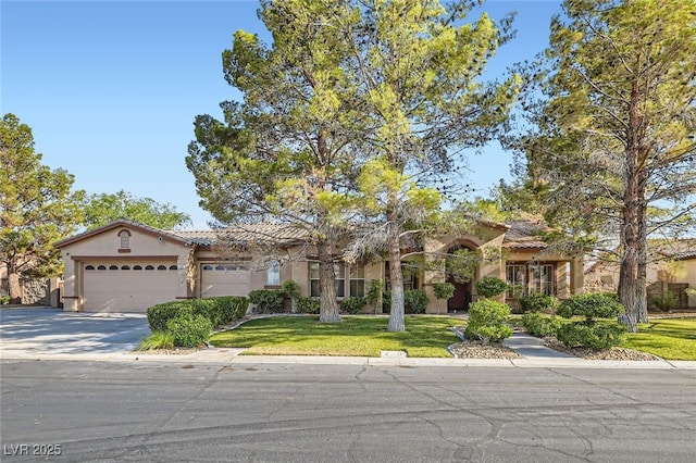 313 Glenridding St, Las Vegas, NV 89183 - mediterranean / spanish-style home featuring stucco siding, a tiled roof, a front lawn, and driveway